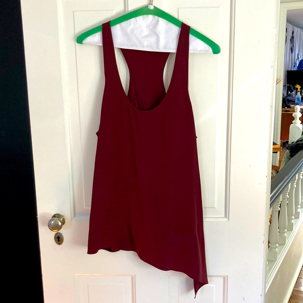 Tibi 100%silk burgundy racer back tank with assymetrical hem and side slit.